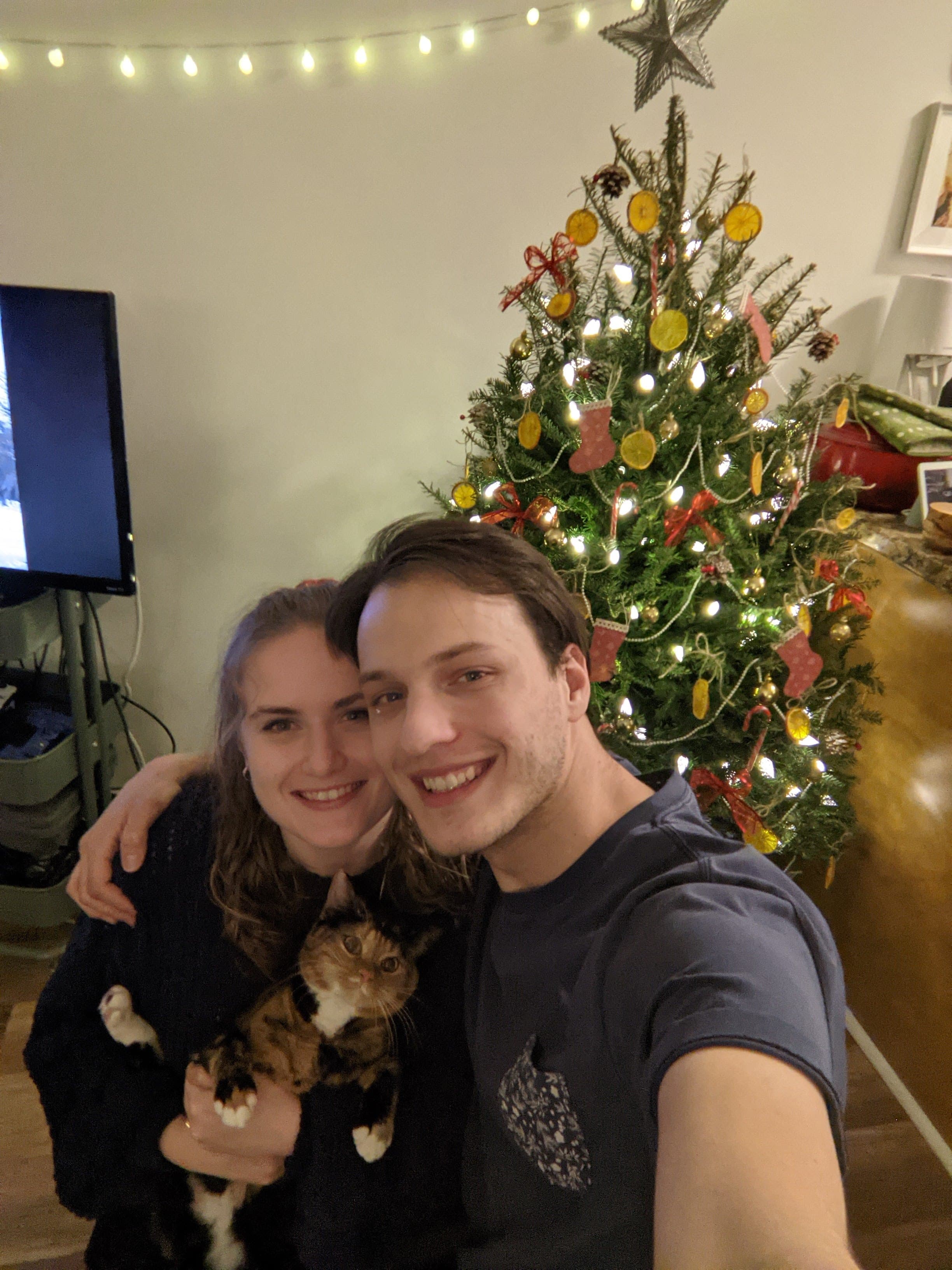 Christian and Sonya during their first Christmas, with Belle the cat